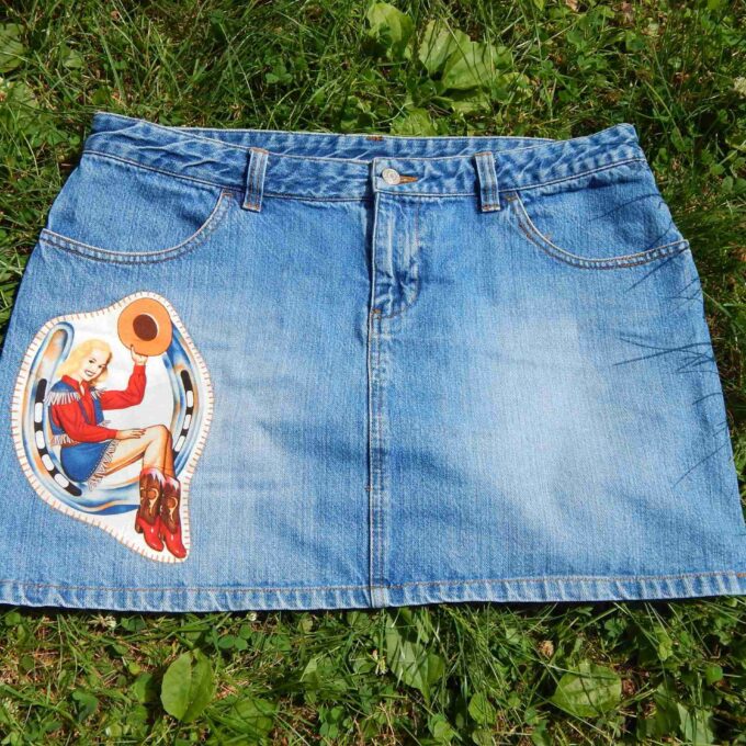 a blue jean skirt with a picture of a woman on it.