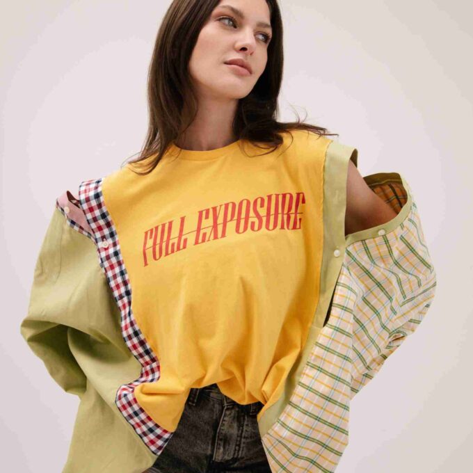 a woman in a yellow shirt and shorts.