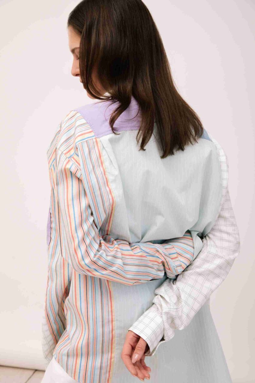 a woman wearing a white and blue striped shirt.