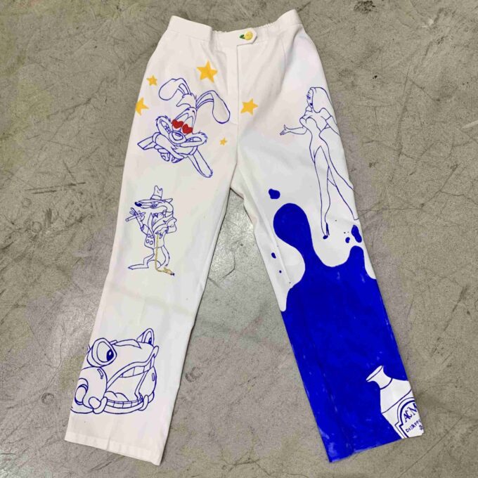 a pair of white pants with cartoon drawings on them.