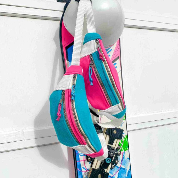 a snowboard hanging from a hook on a wall.