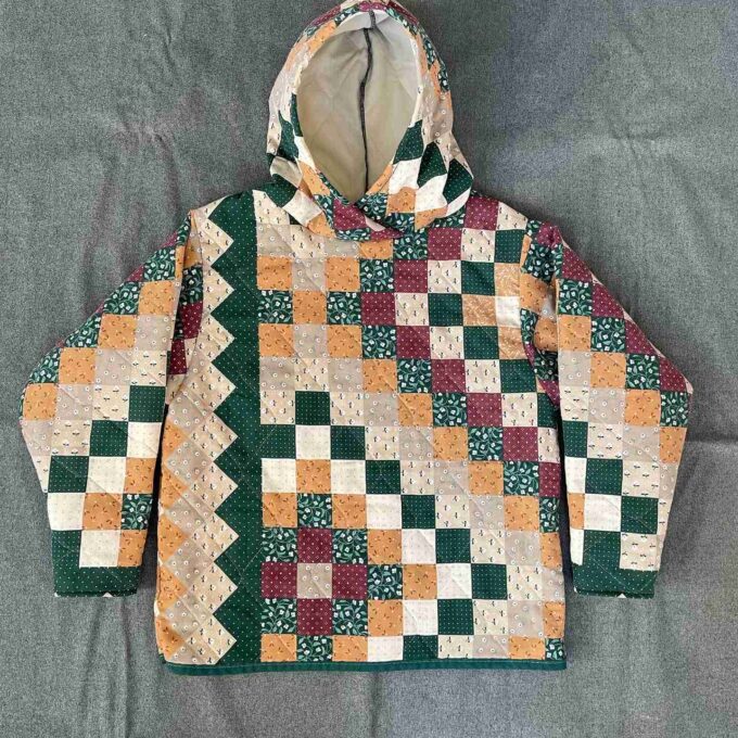 a green, orange, and white jacket with a hood.
