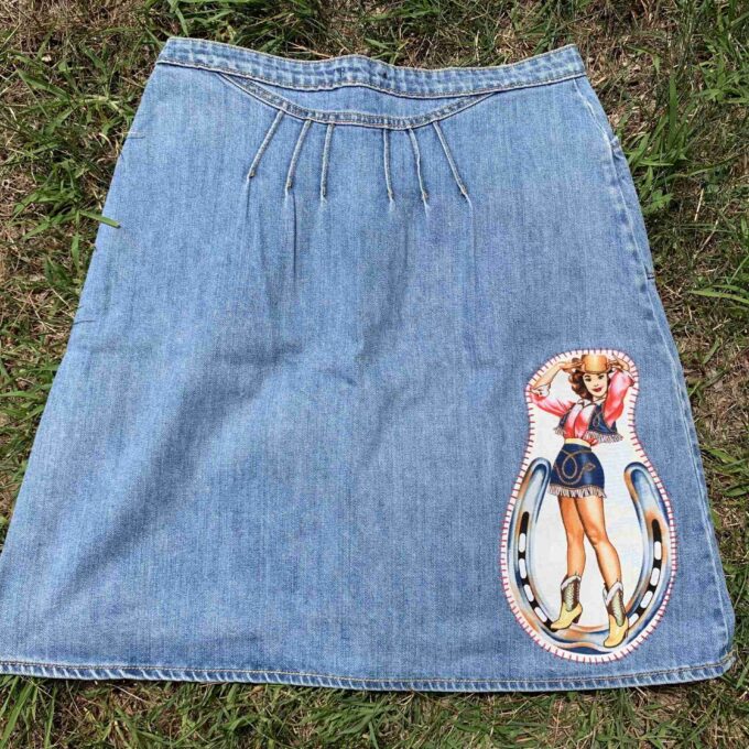 a blue jean skirt with a picture of a woman on it.