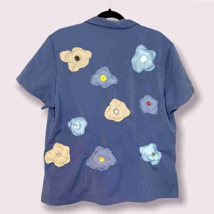 a blue shirt with flowers on it.