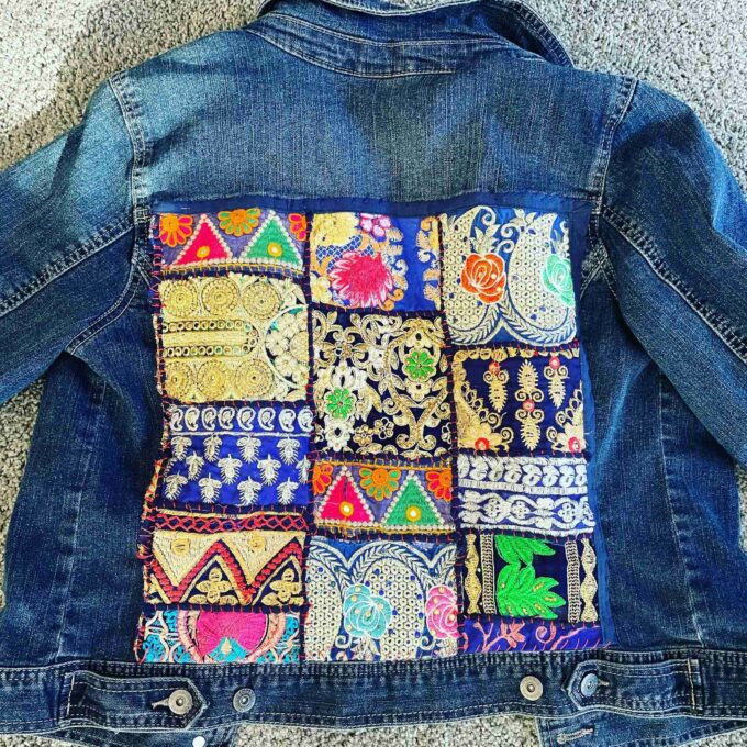 a denim jacket with a patchwork design on it.
