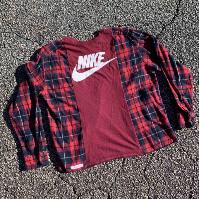 a red and black plaid shirt laying on the ground.