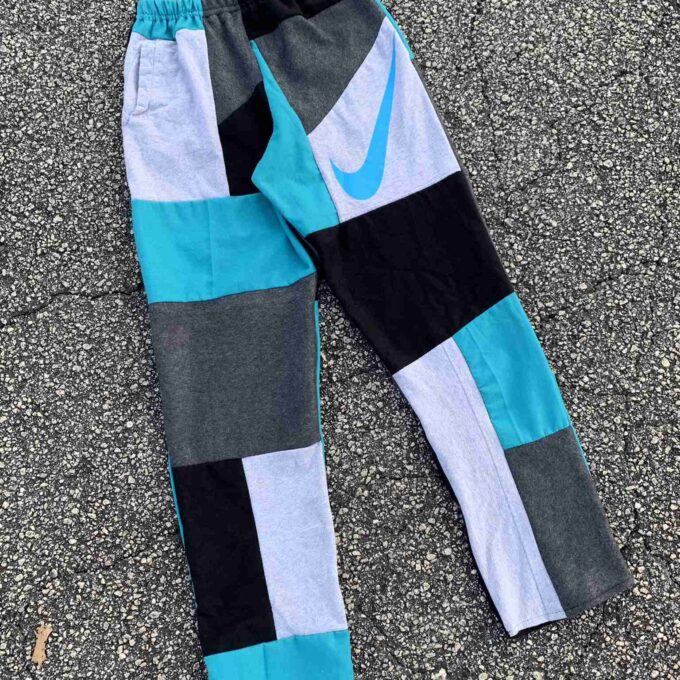 a pair of nike pants laying on the ground.