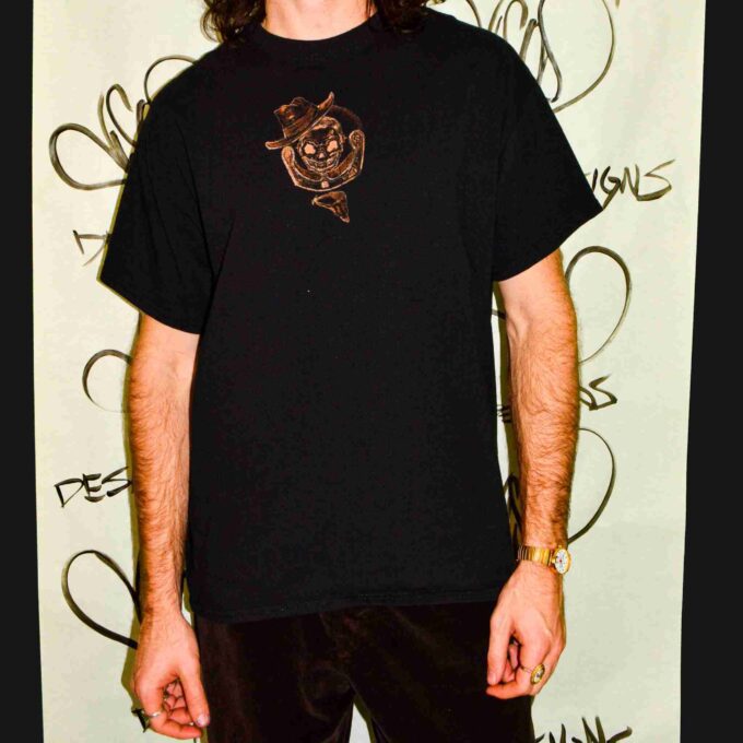 a man with long hair wearing a black shirt.