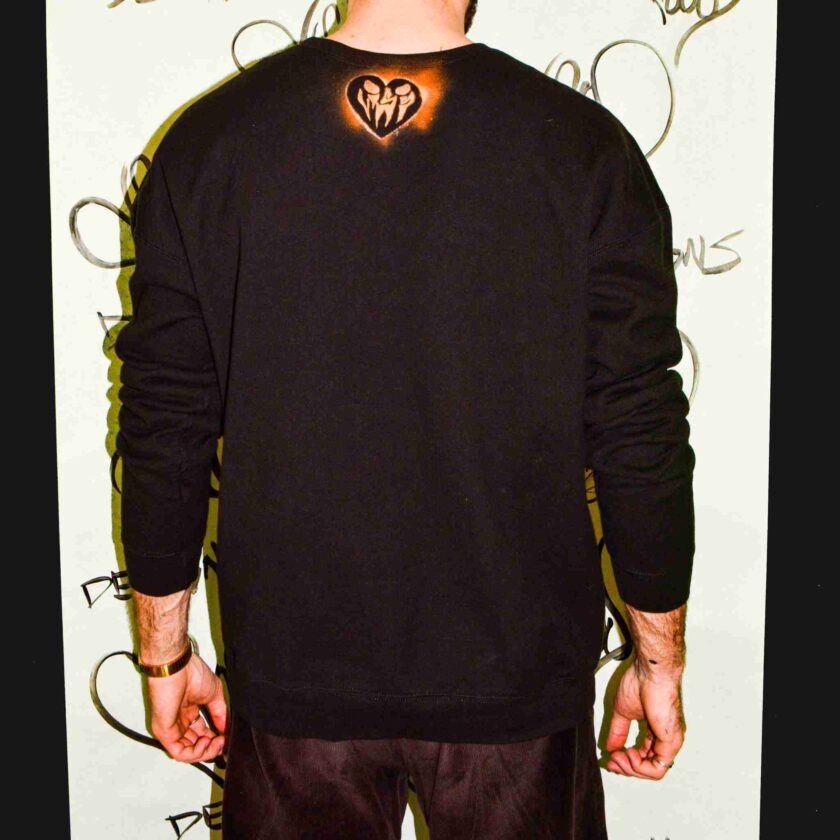 a man with a heart tattoo on his back.