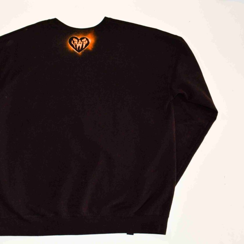 a black sweatshirt with a heart on it.