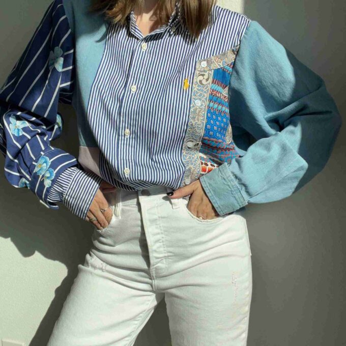 a woman wearing a striped shirt and white pants.