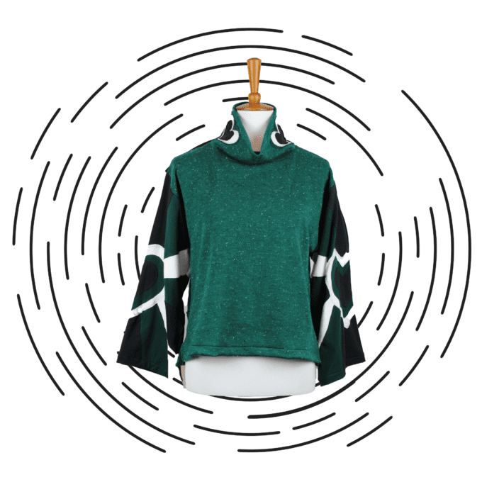 a green sweater hanging on a clothes rack.
