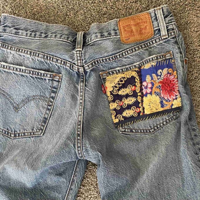 a pair of jeans with a patch on the back.