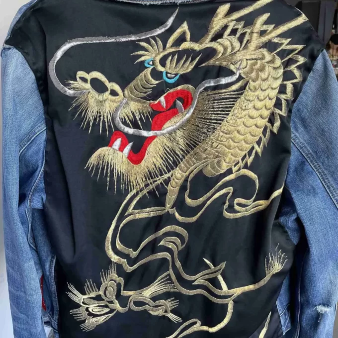 a man wearing a jacket with a dragon on it.