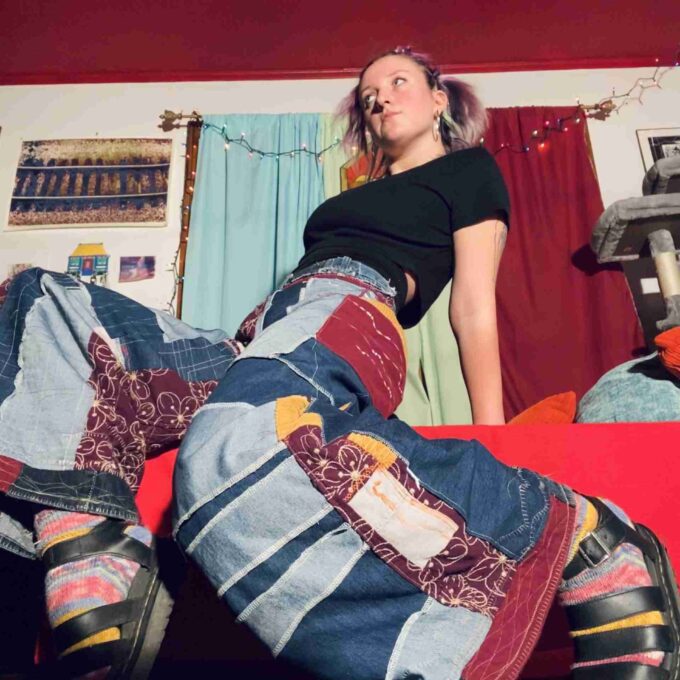 a woman laying on top of a bed in a room.