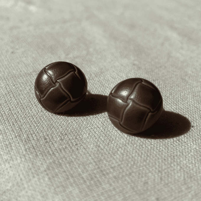 a couple of brown balls sitting on top of a table.
