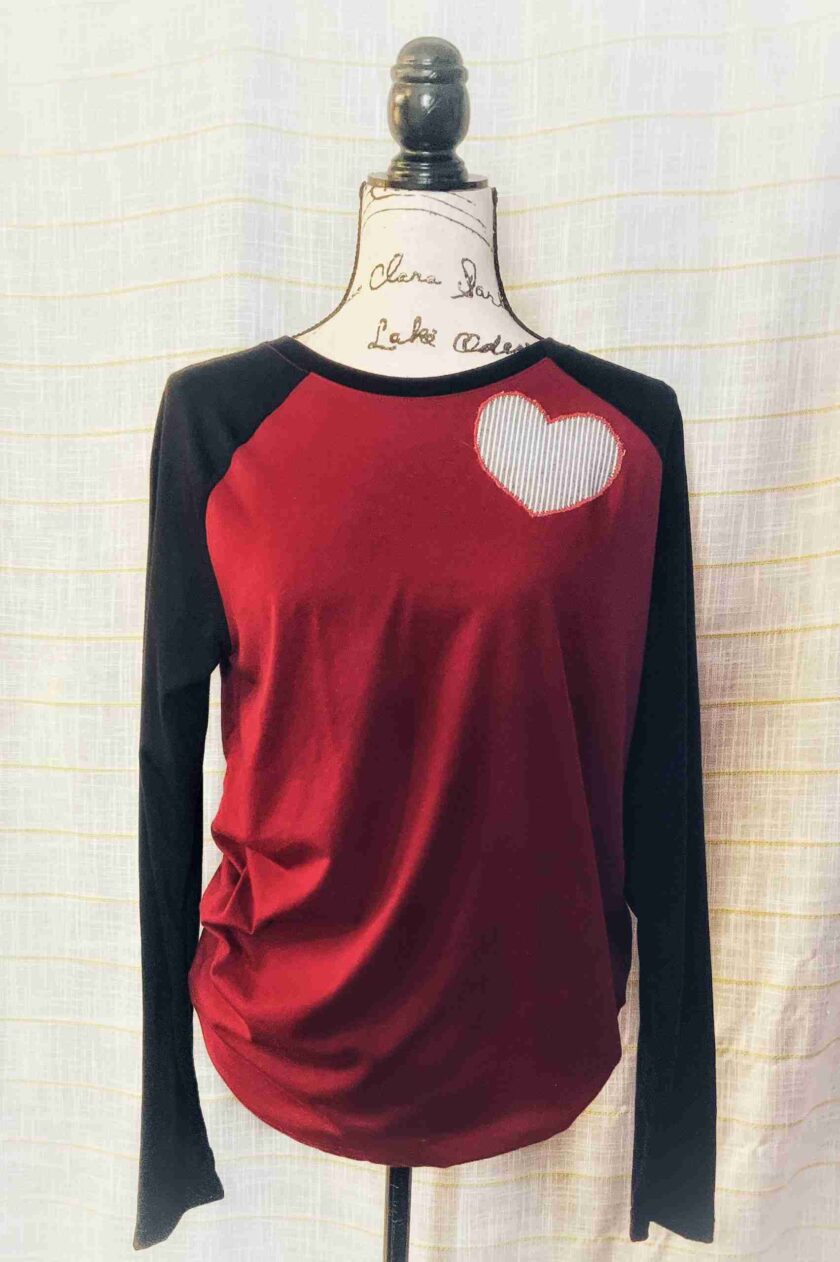 a red and black shirt with a heart on it.