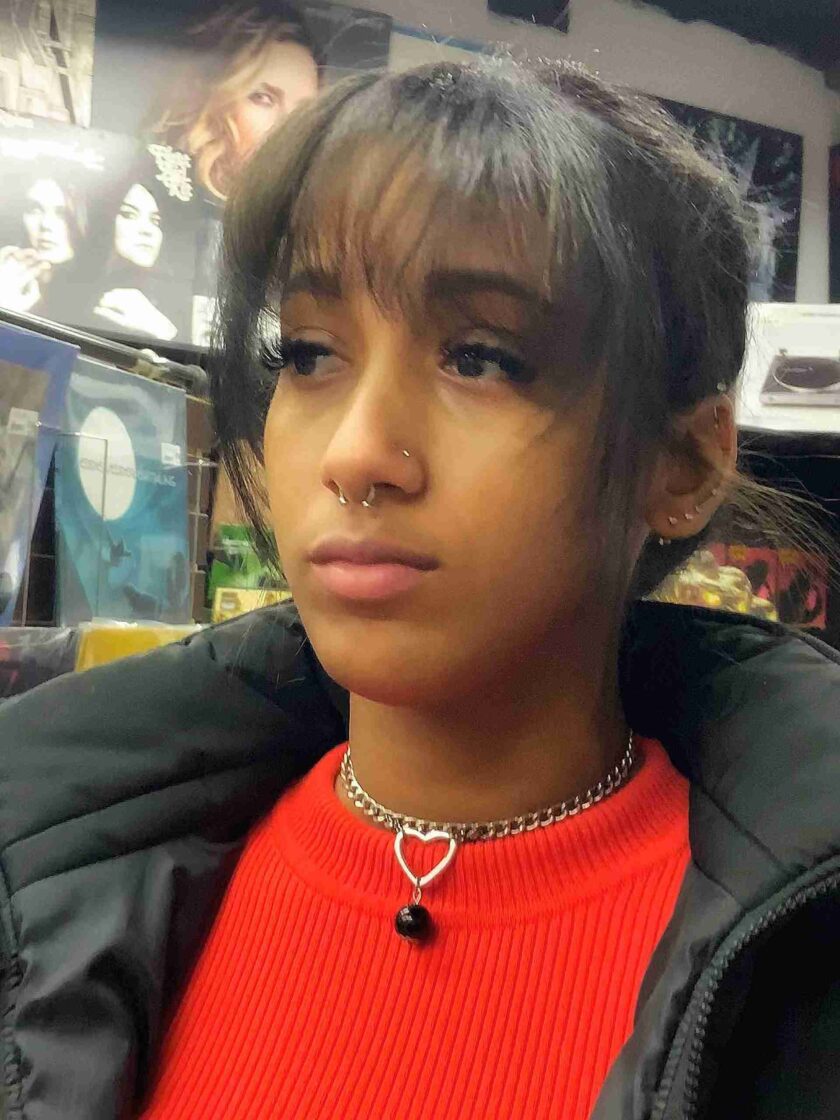 a girl with a fake nose ring on her neck.
