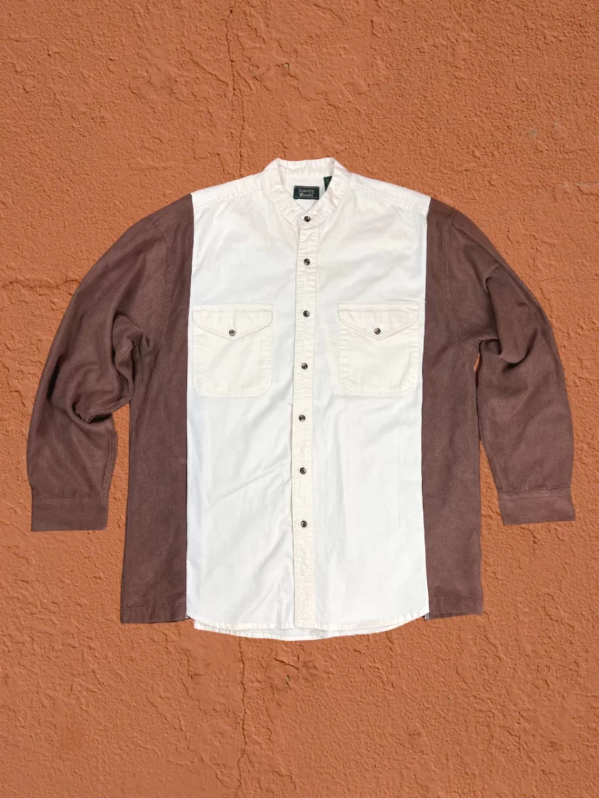 a brown and white shirt hanging on a wall.