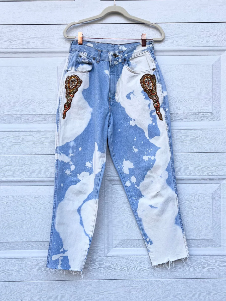 a pair of blue and white jeans with a picture of an ice cream cone on.
