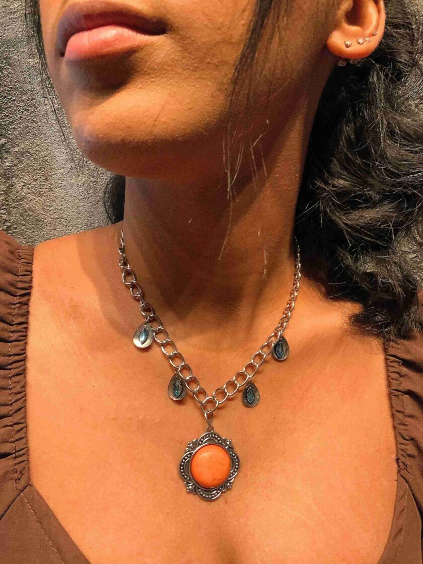 a close up of a woman wearing a necklace.