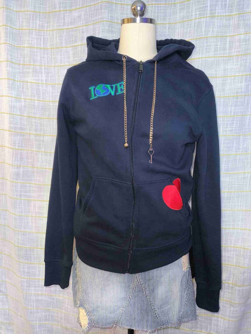 a mannequin wearing a hoodie with a heart on it.