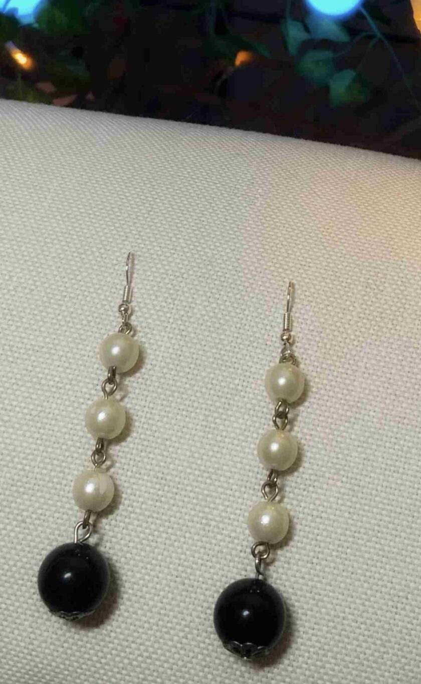 a pair of black and white earrings.