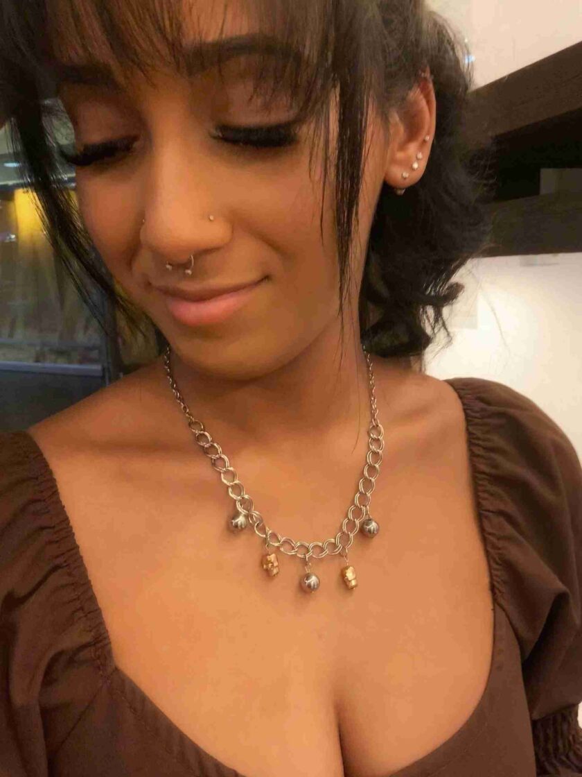 a close up of a person wearing a necklace.