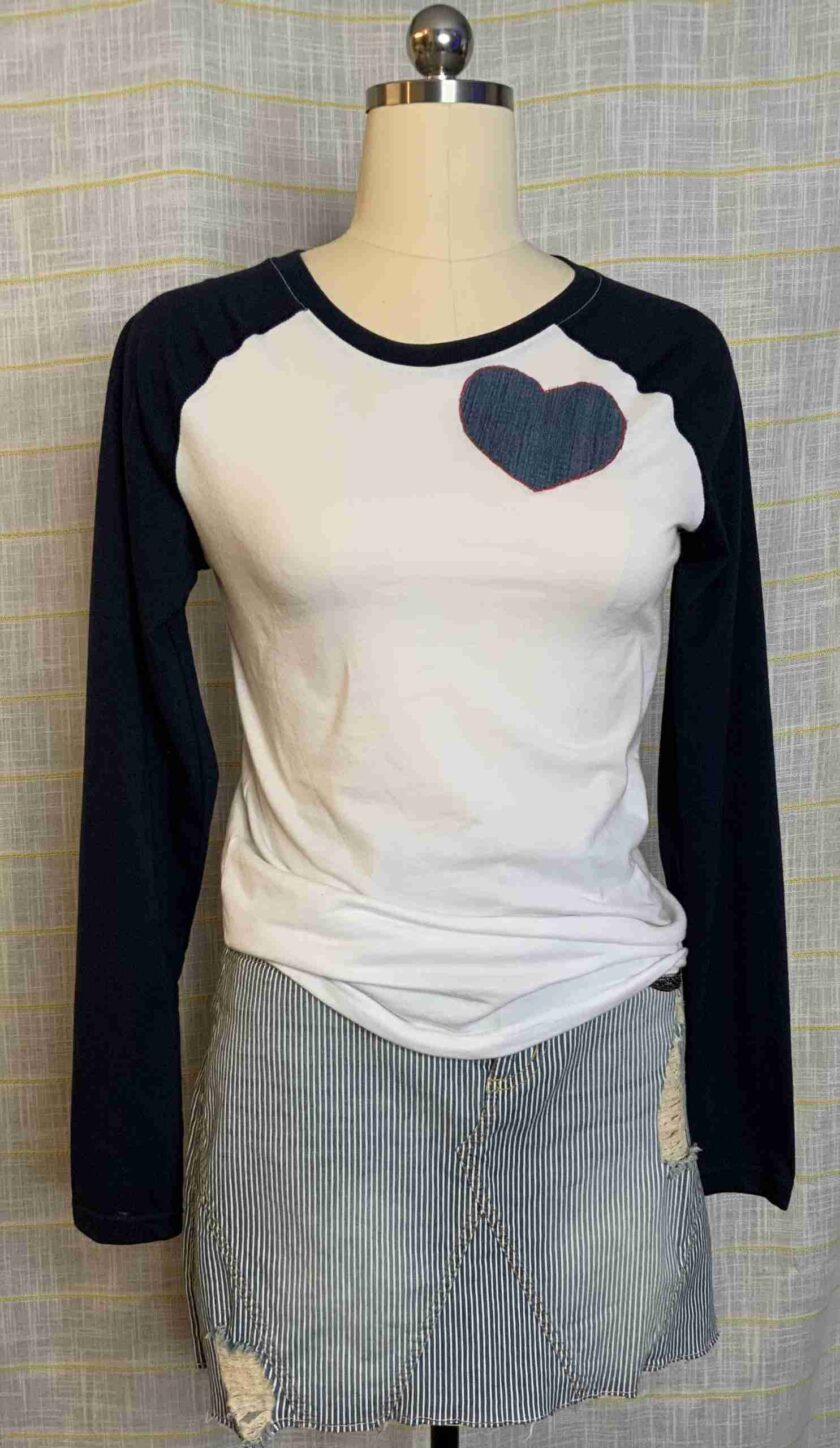 a white and black top with a heart on it.