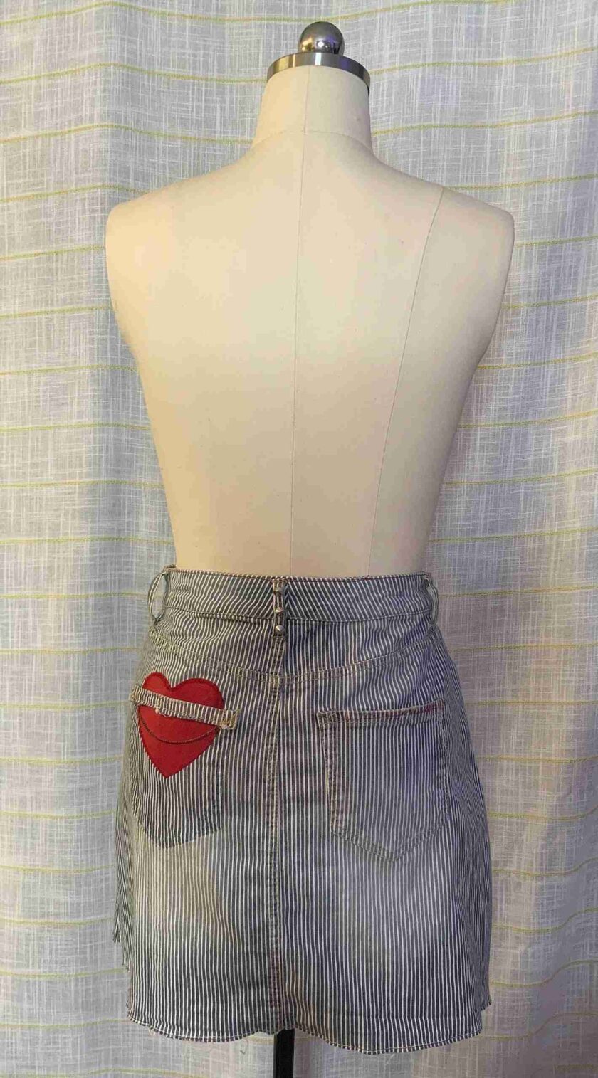 a mannequin wearing a skirt with red lips on it.