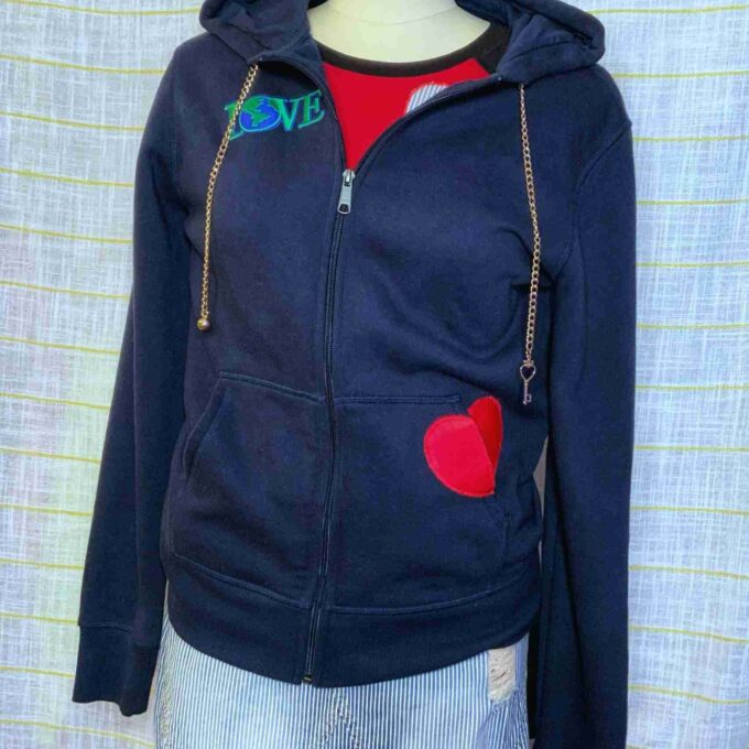 a blue hoodie with a heart patch on it.