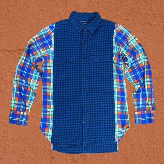 a blue and green plaid shirt hanging on a wall.