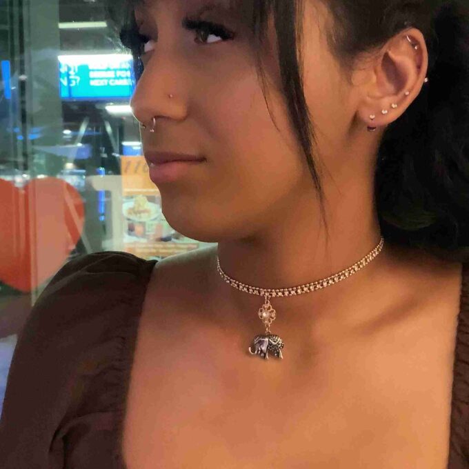 a close up of a person wearing a necklace.