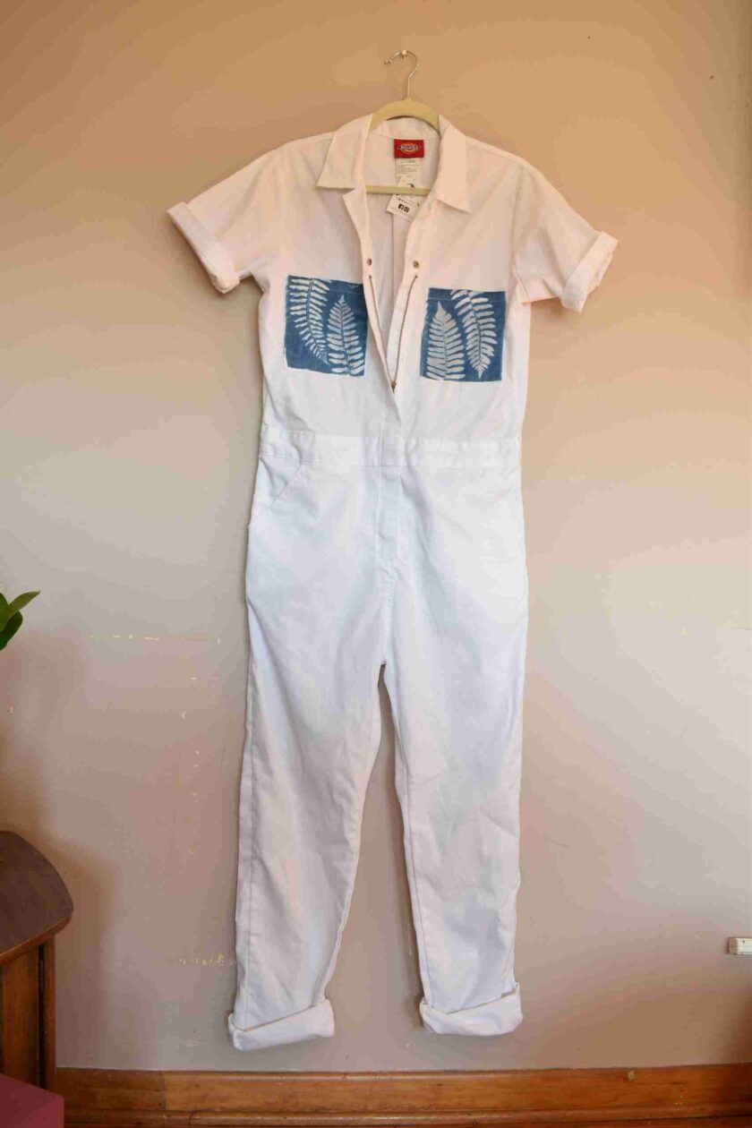 a white shirt and white pants hanging on a wall.