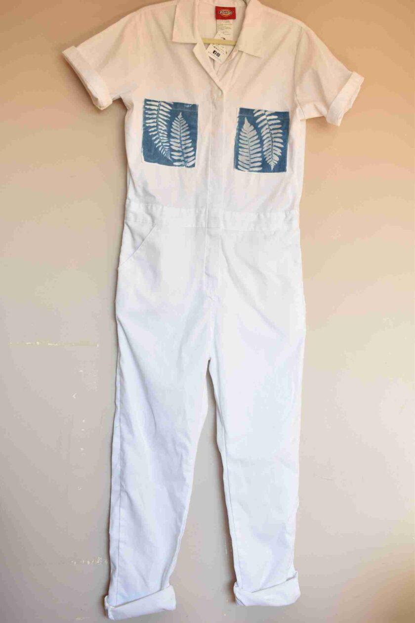 a white jumpsuit hanging on a wall.