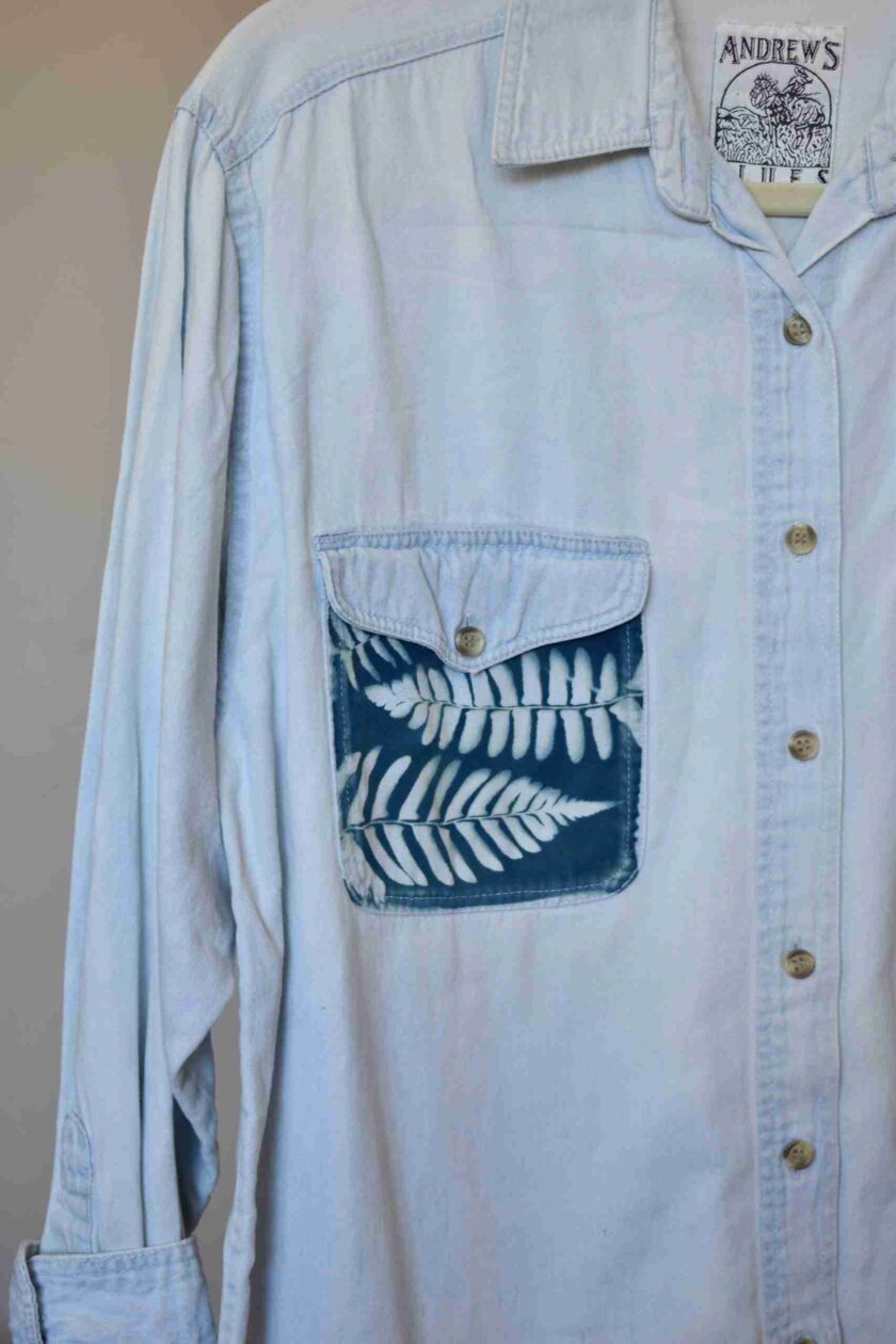 a blue shirt with a white feather on it.