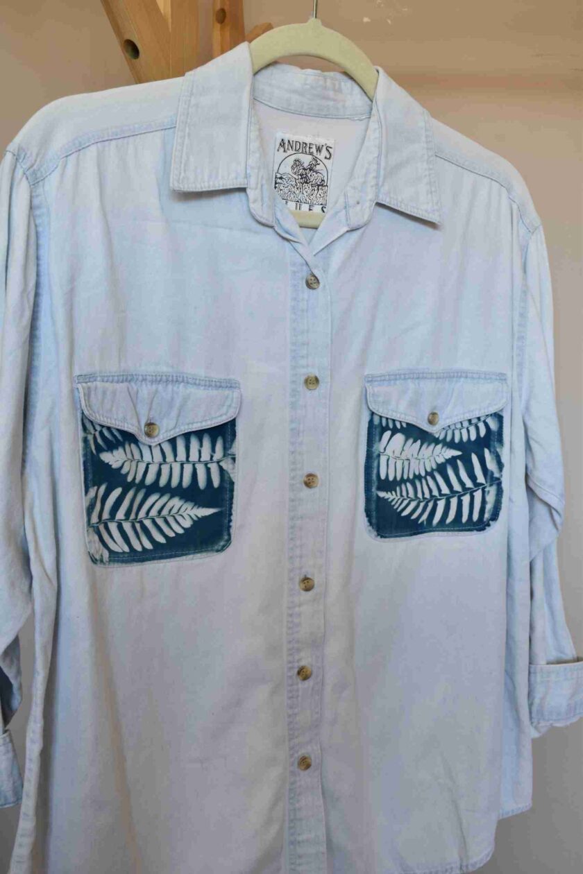 a white shirt with blue and white leaves on it.