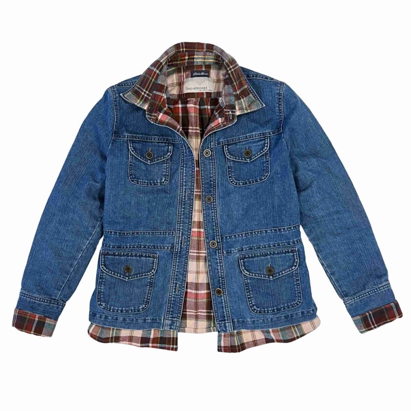 a blue jean jacket with a plaid shirt underneath it.