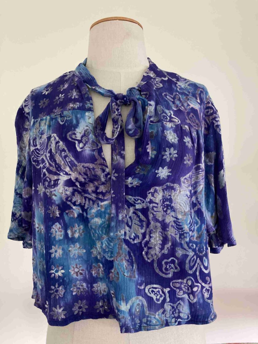 a mannequin wearing a blue shirt with a tie.