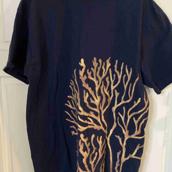 a black t - shirt with a gold tree on it.