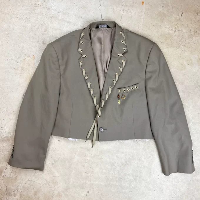a gray jacket with a tie around it.