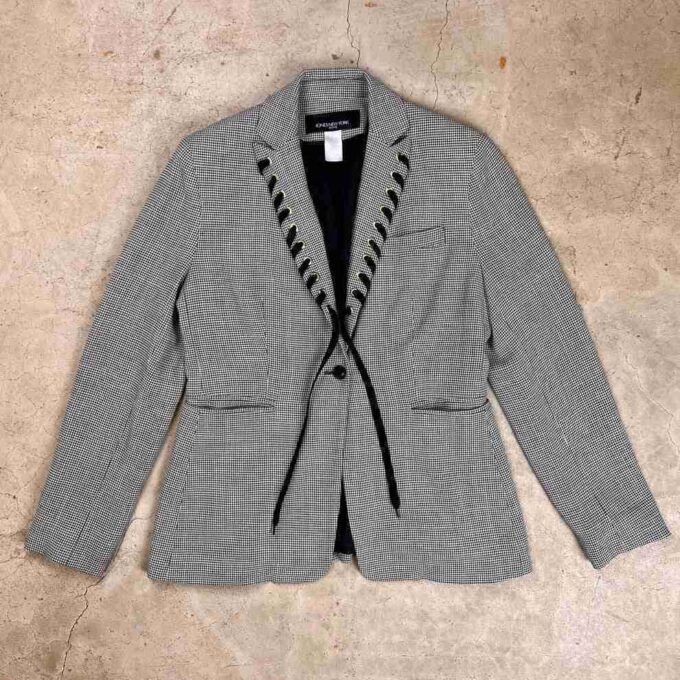 a gray jacket with black laces on it.