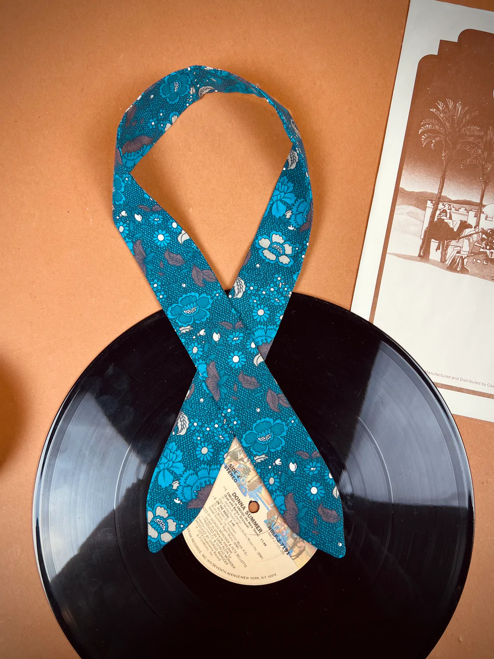 a record with a blue ribbon on top of it.