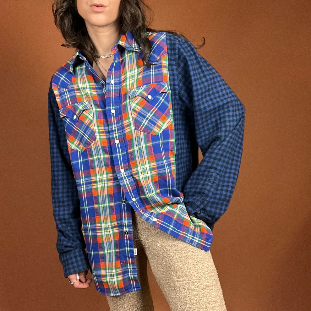 a woman in a plaid shirt poses for a picture.