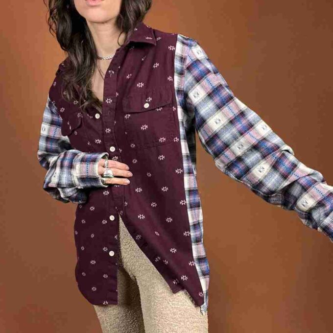 a woman is posing for a picture wearing a plaid shirt.
