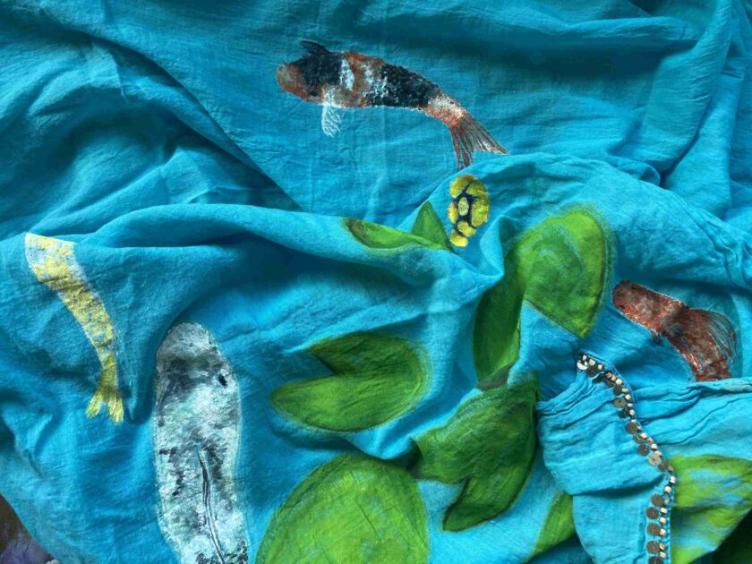 a close up of a blue cloth with fish on it.