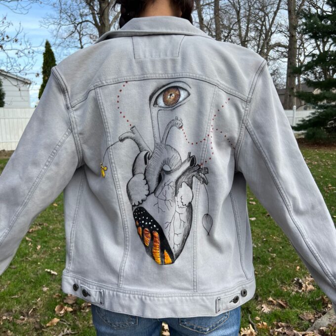 a woman wearing the Anatomy Heart and the Transformation Within - Handpainted and handstitched jacket.