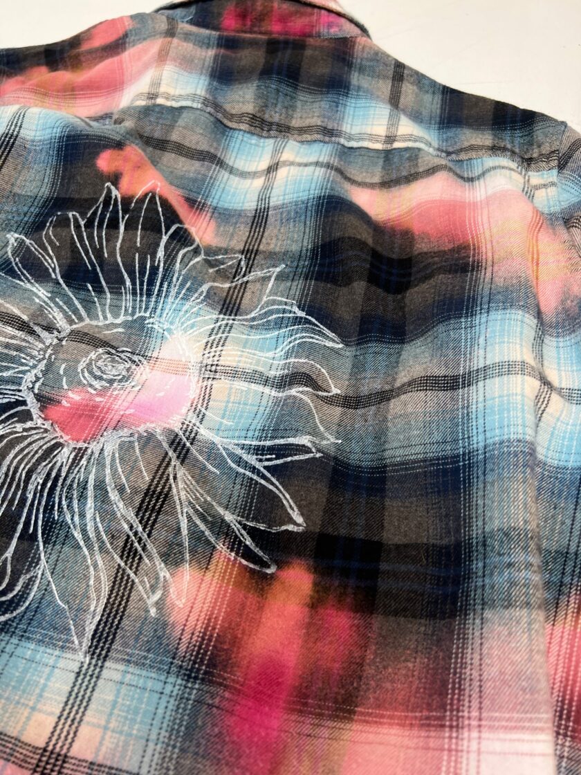 A close up of Sunflower Bleached Flannel with a flower on it.
