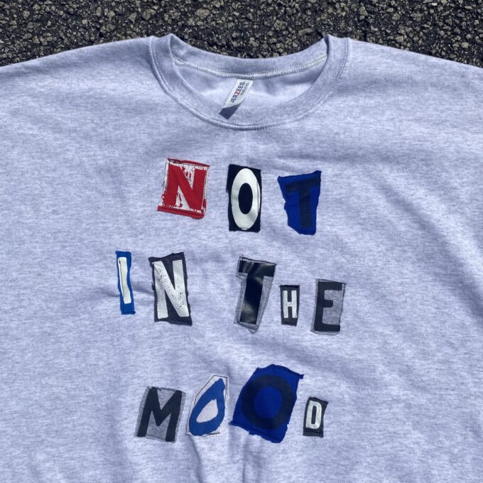 a t - shirt that says no in the mood on it.