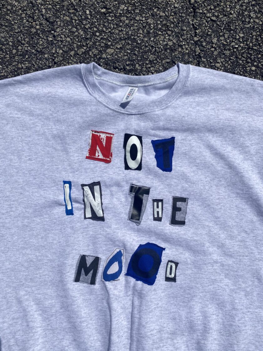 a t - shirt that says no in the mood on it.